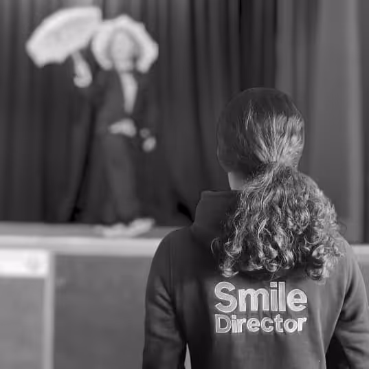 A youngster directing a performer on stage