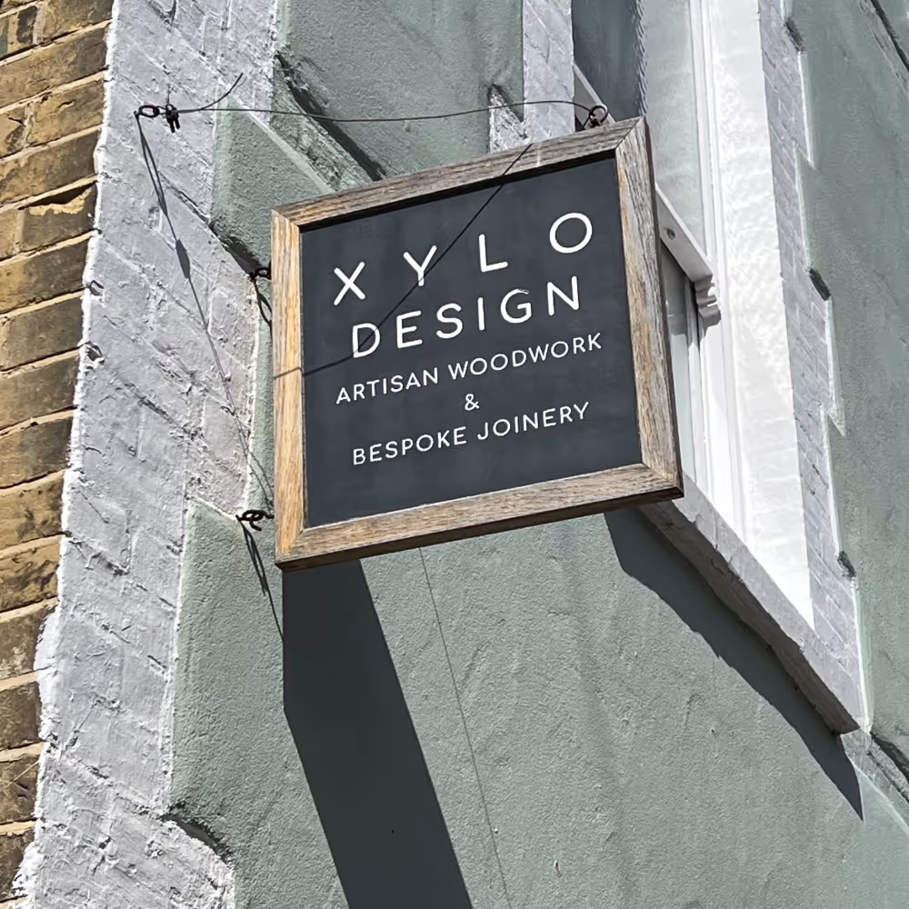 A shop sign fixed to the exterior of a building