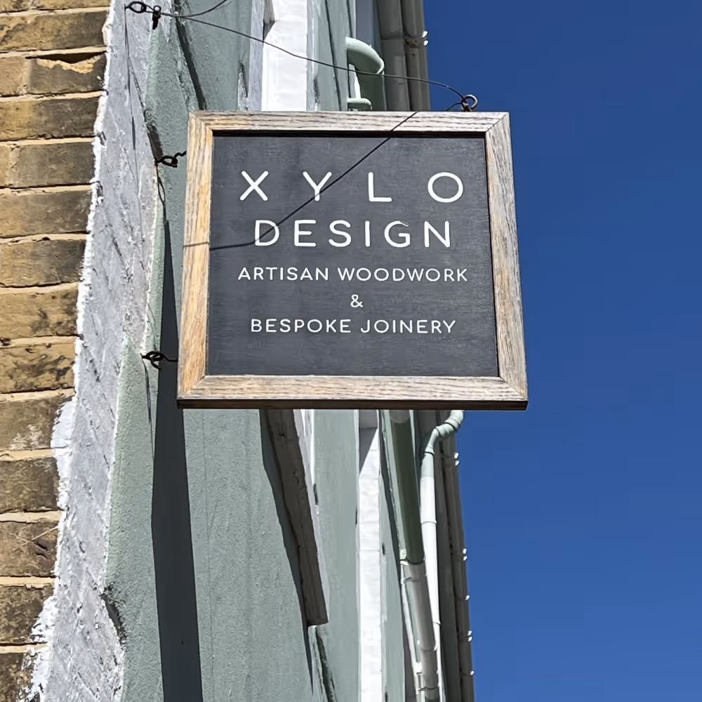 A shop sign fixed to the exterior of a building