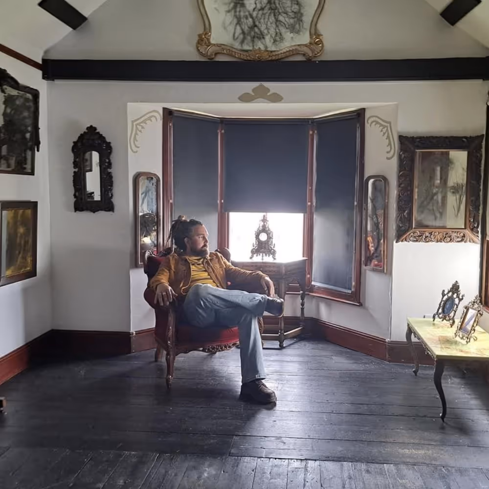 An artist sitting in his gallery