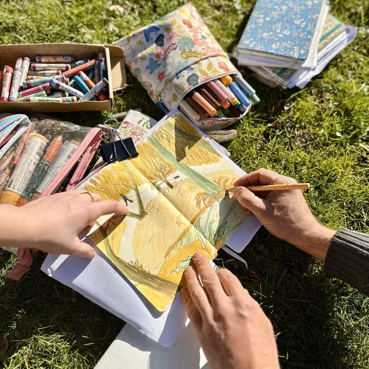 Someone being shown how to draw