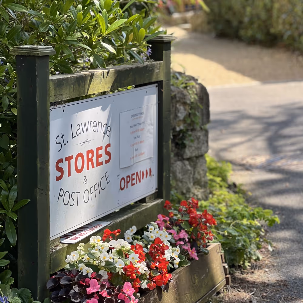 Outdoor sign advertising a local villages stores