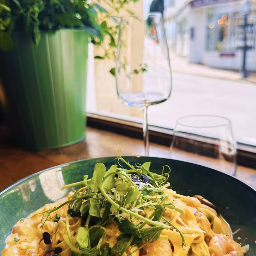 A pasta dish at a table overlooking the street