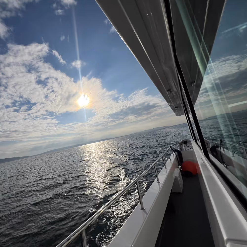 A rising sun seen from a boat on the ocean
