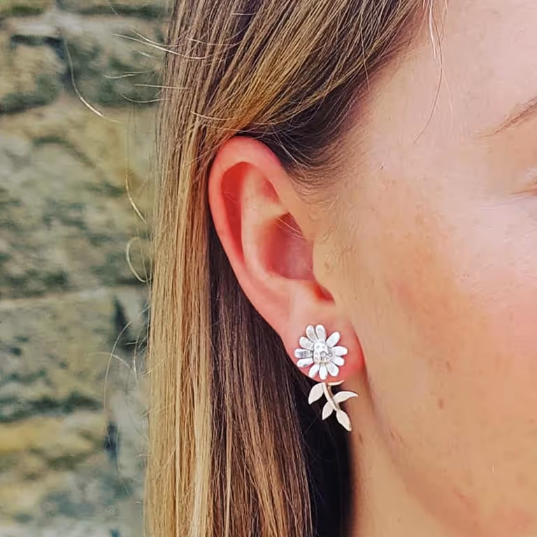Lady wearing a cute dairy earring in sterling silver