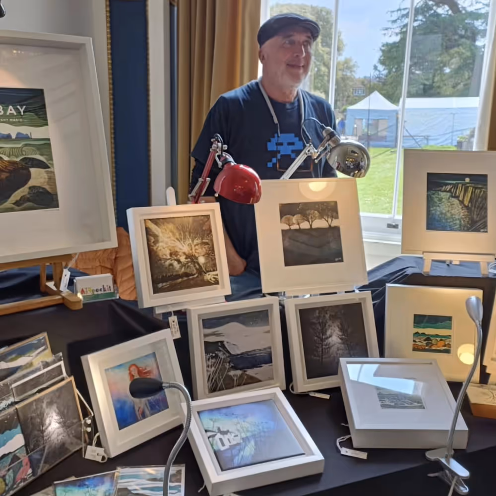 An artists exhibiting his work at a show