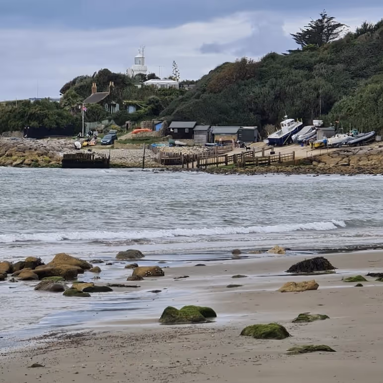 Looking across a cove to fishing boats on the beach