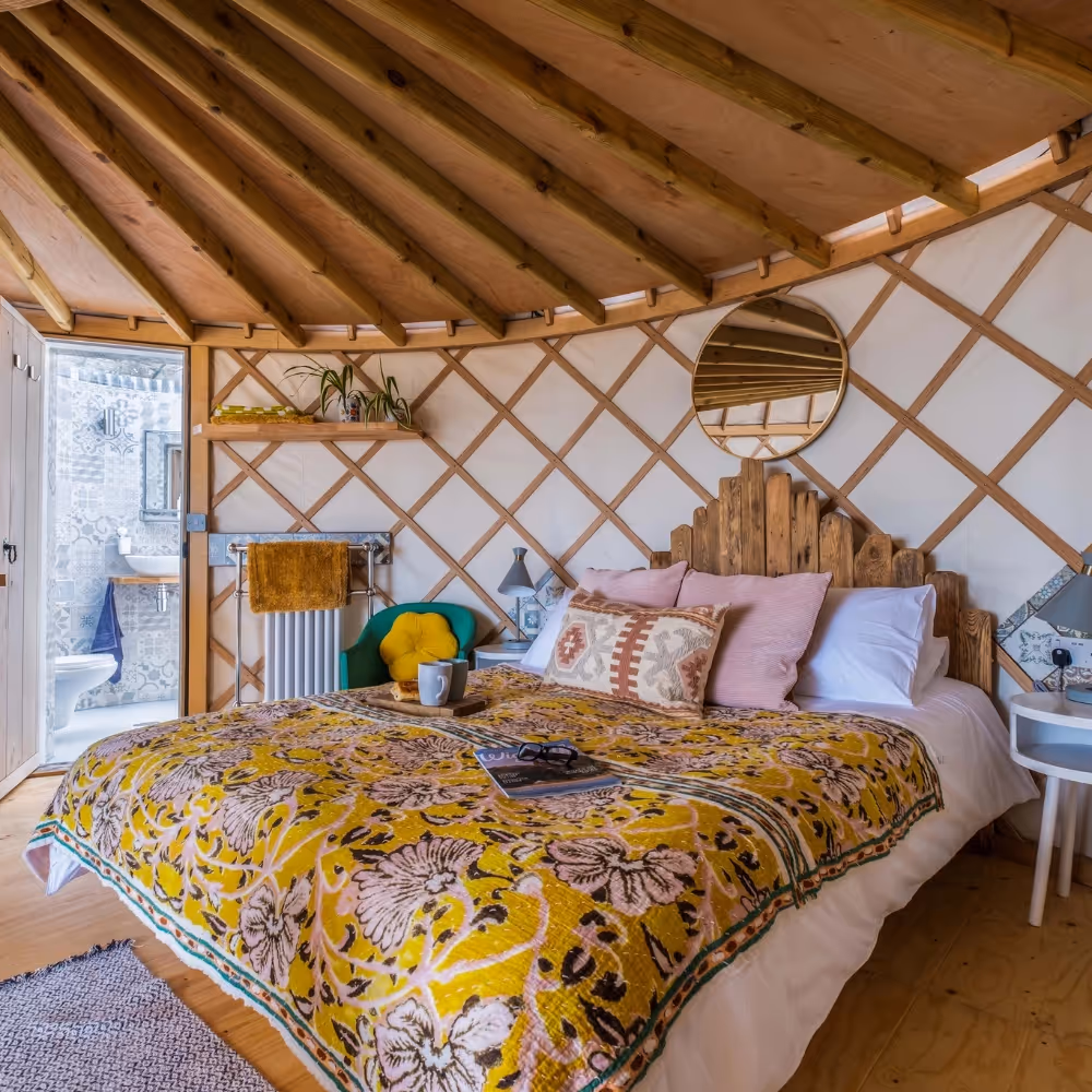 A bed inside a glamping yurt
