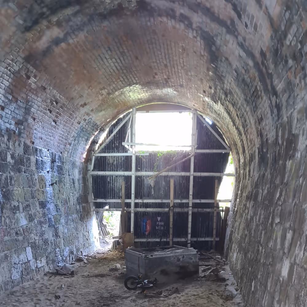 The interior of a boarded up disused railway tunnel