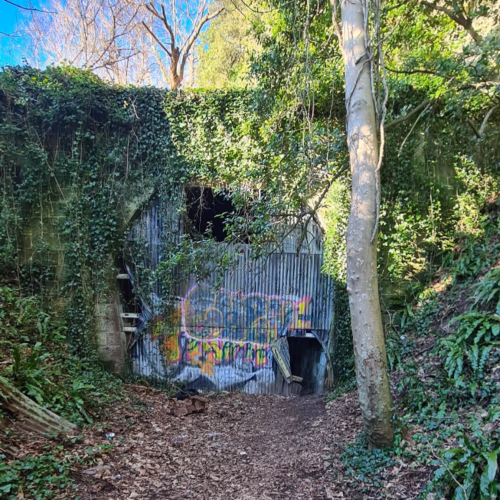 A boarded up entrance to a disused railway tunnel