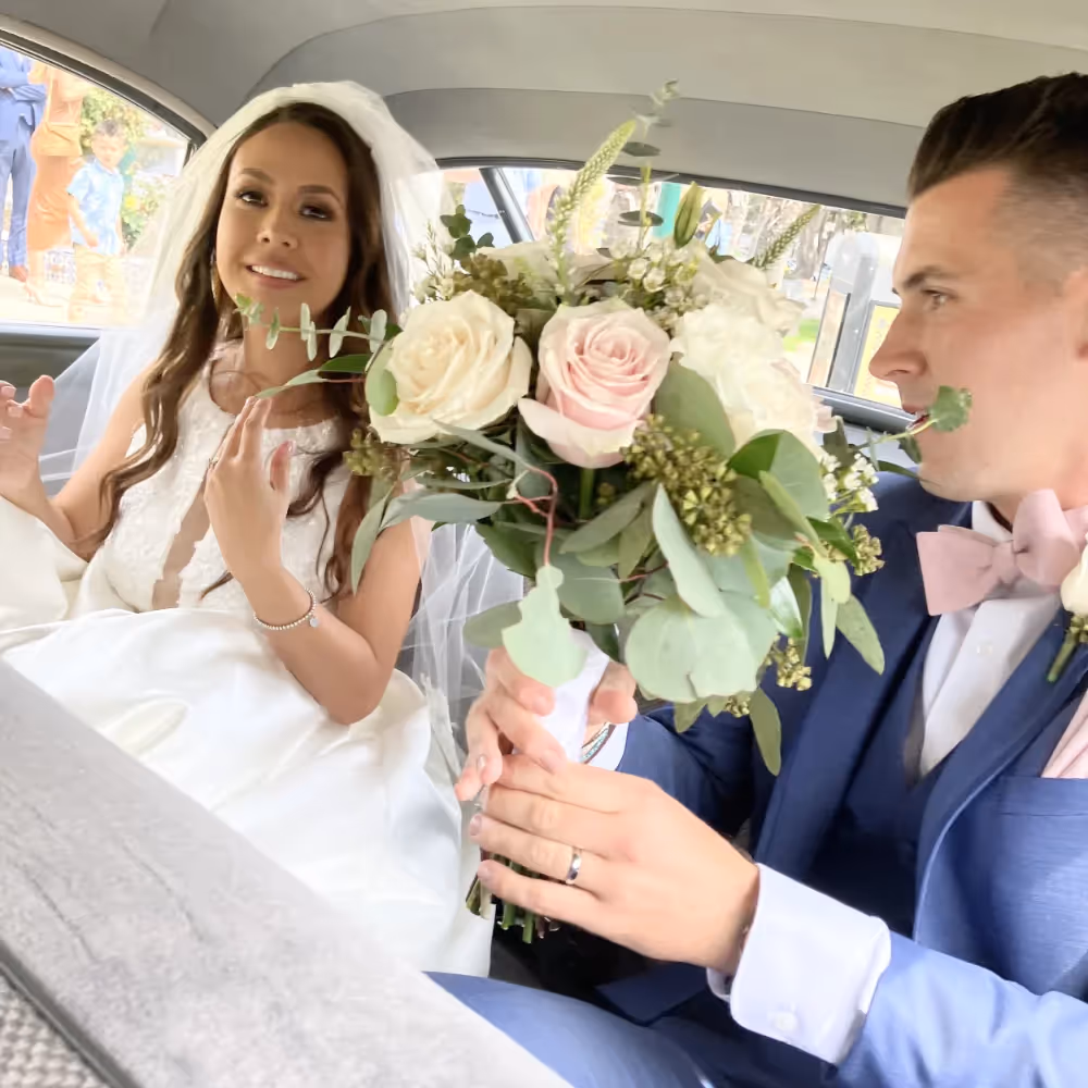 A newly wed couple in their classic car