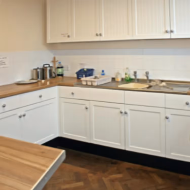 A cream shaker kitchen with oak worktops