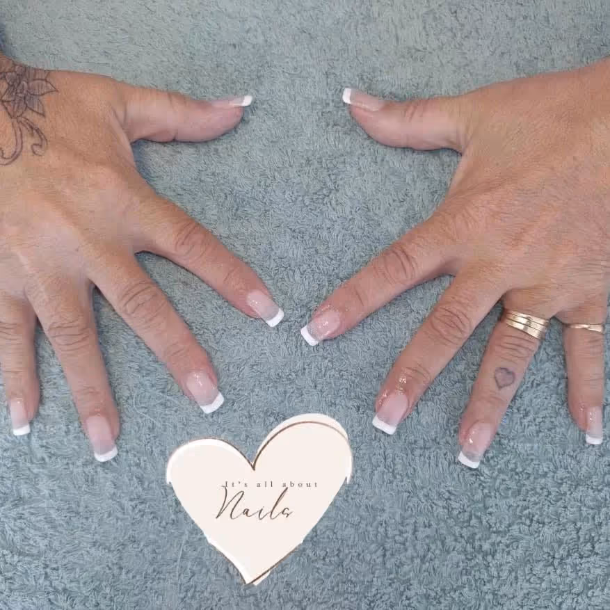 A pair of hands showing off a French manicure