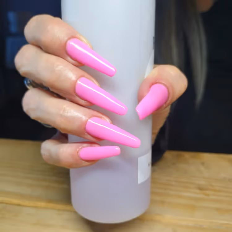 A lady's hand with very long pink nails