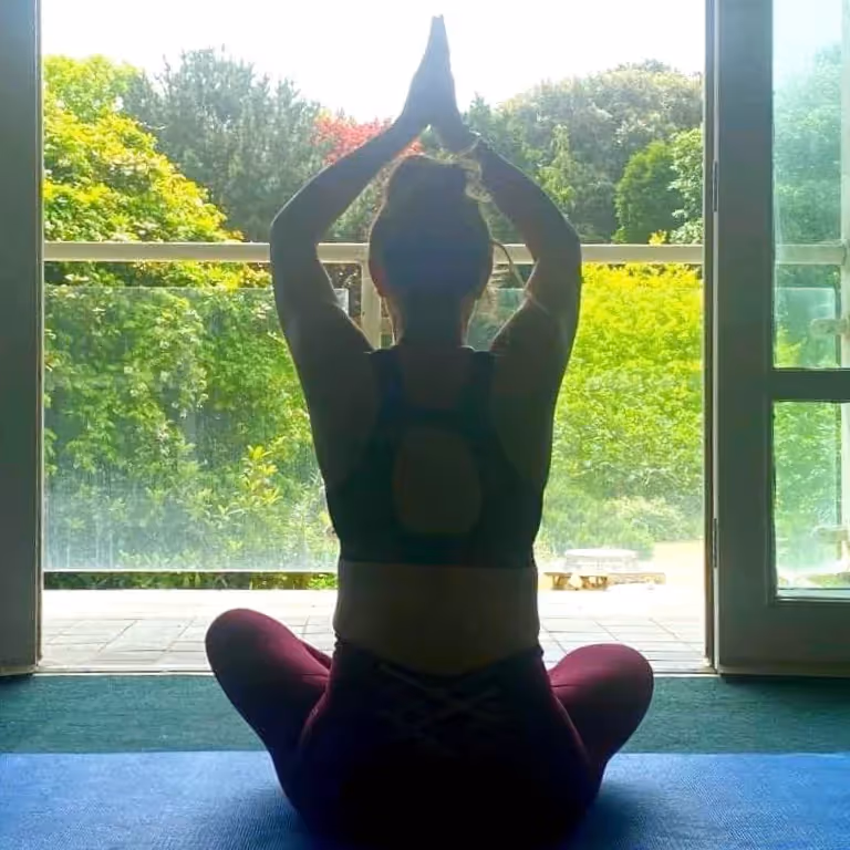 A woman in a seated yoga pose