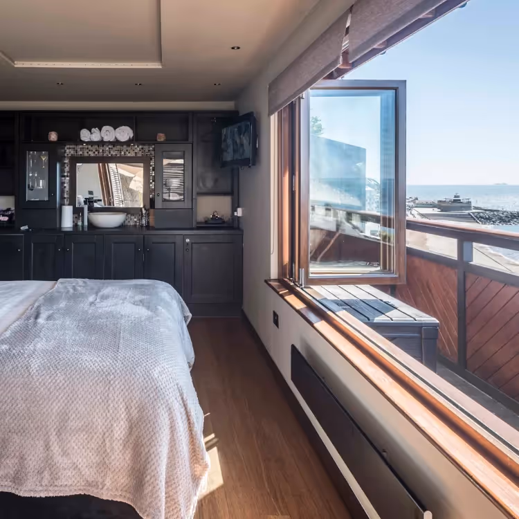 A bedroom with a perfect sea view through the bi-fold doors