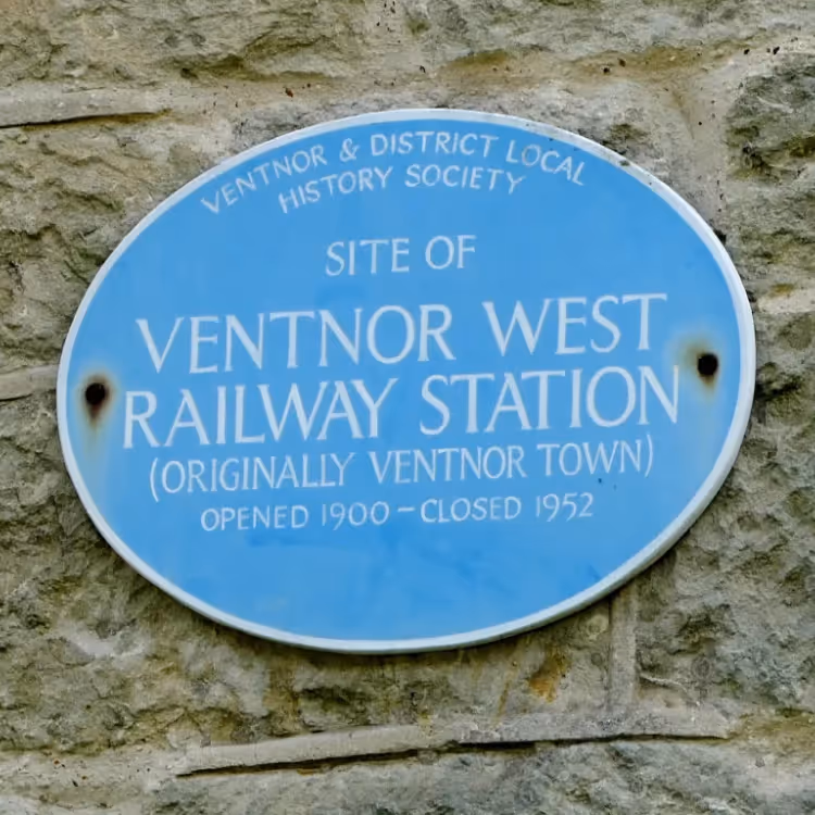 Historical blue plaque on a stone wall