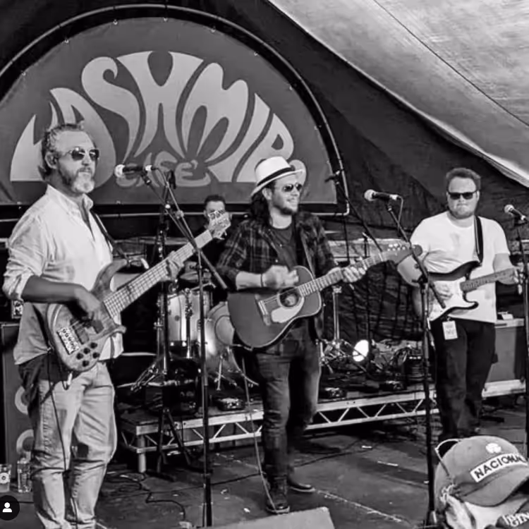 A band performing on stage at a festival