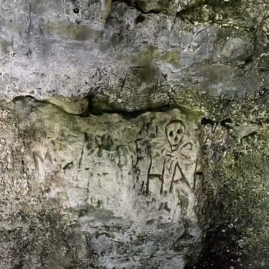 Carving on the wall of a cave