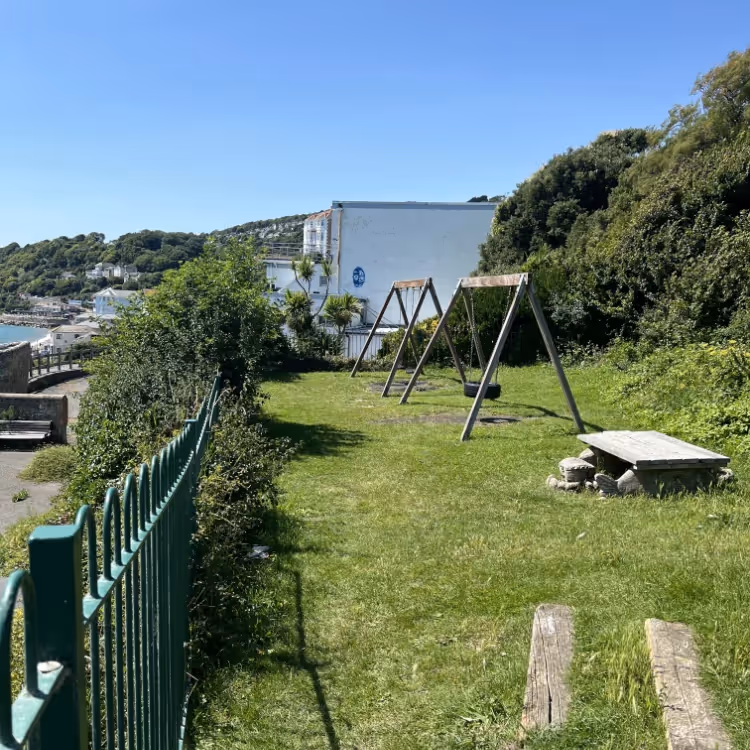 A kids playground overlooking a seaside town