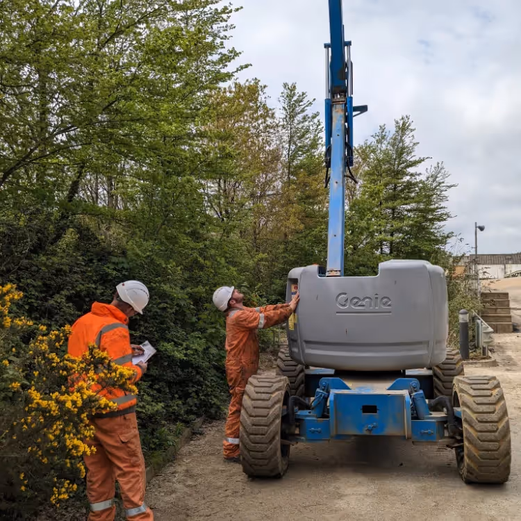 Two men operating a crane