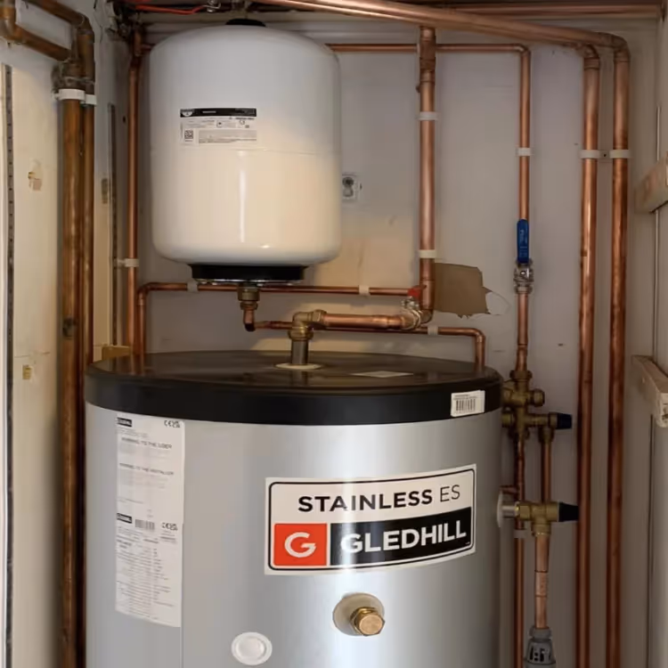 A hot water cylinder in a cupboard