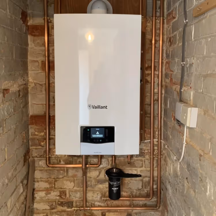 A boilet being installed in a brick cupboard