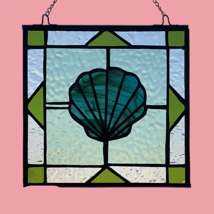 A hanging stained glass picture of a shell
