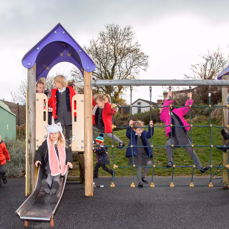 Kids playing on a playground climbing frame