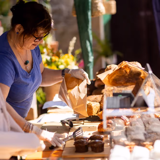 A lady selling bread in a market