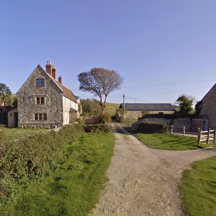 A stone farmhouse in a rural setting
