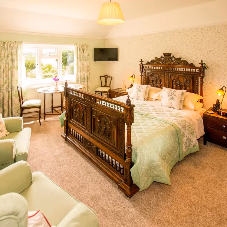 An elegant green bedroom with traditional furniture