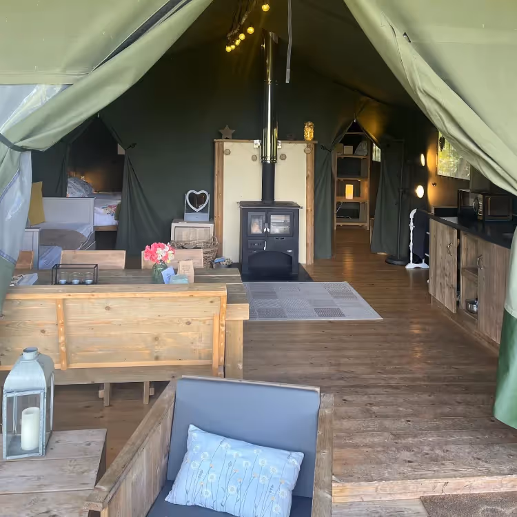 Looking into a glamping tent with a mini kitchen