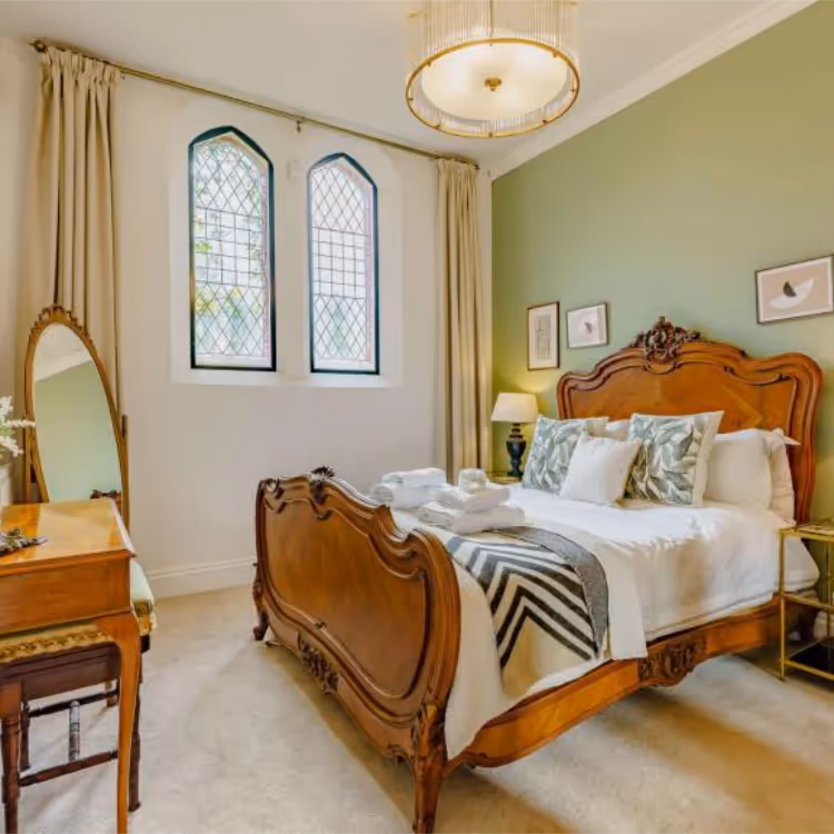 An elegant traditional bedroom in a converted chapel