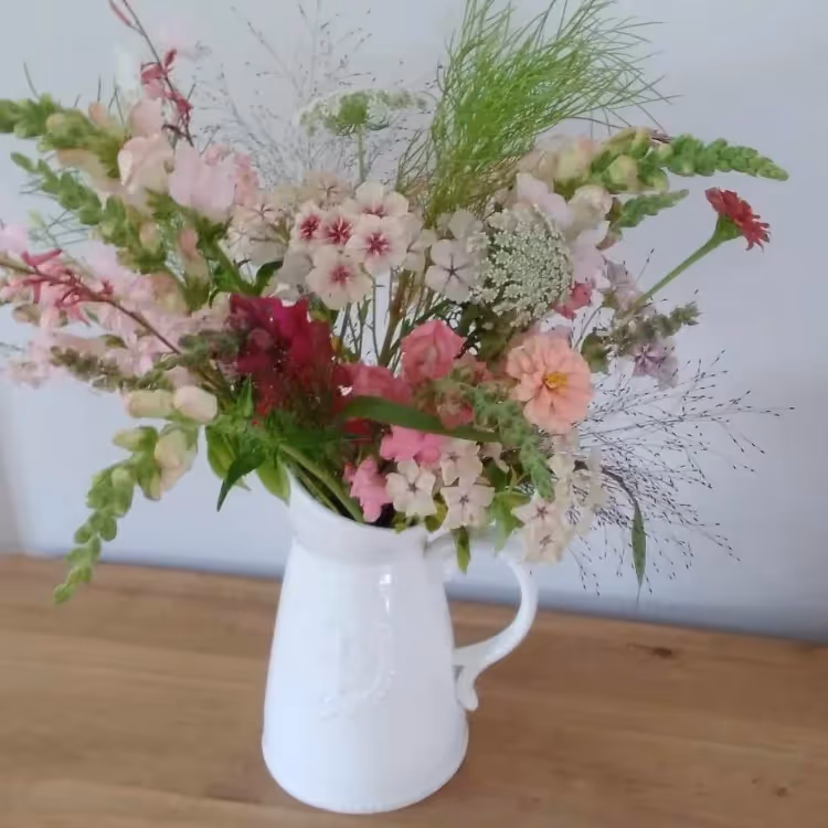Fresh cut flowers in a white jug