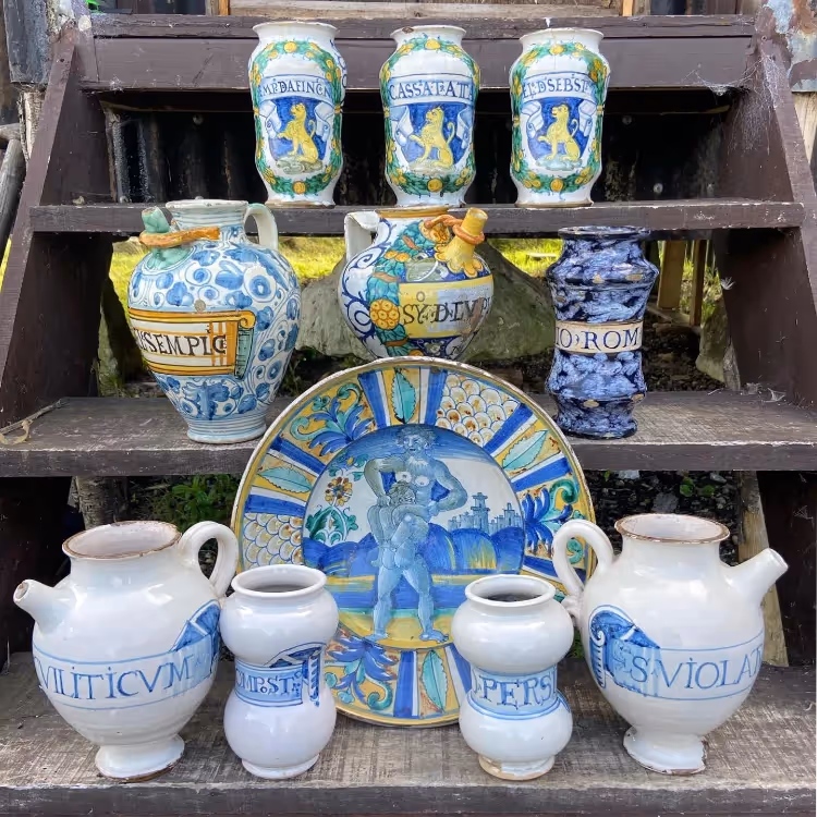 A selection of Delft china displayed on some wooden steps