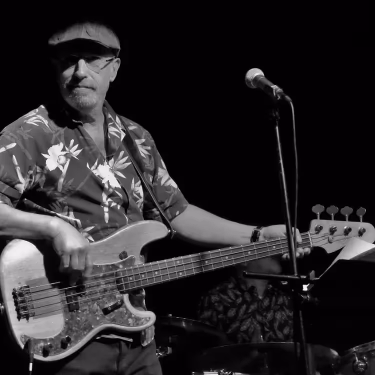 A man playing electric bass guitar