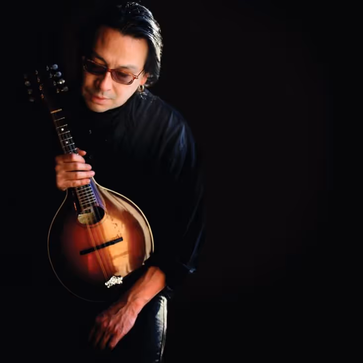 A man holding an acoustic instrument