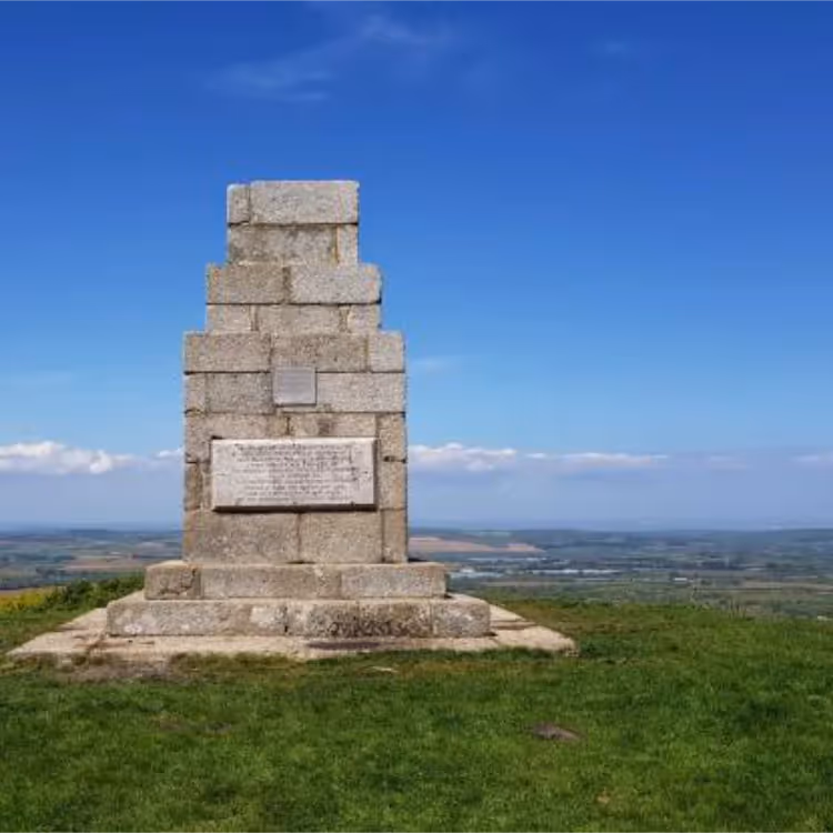 A granite monument on top of a hill with panoramic views