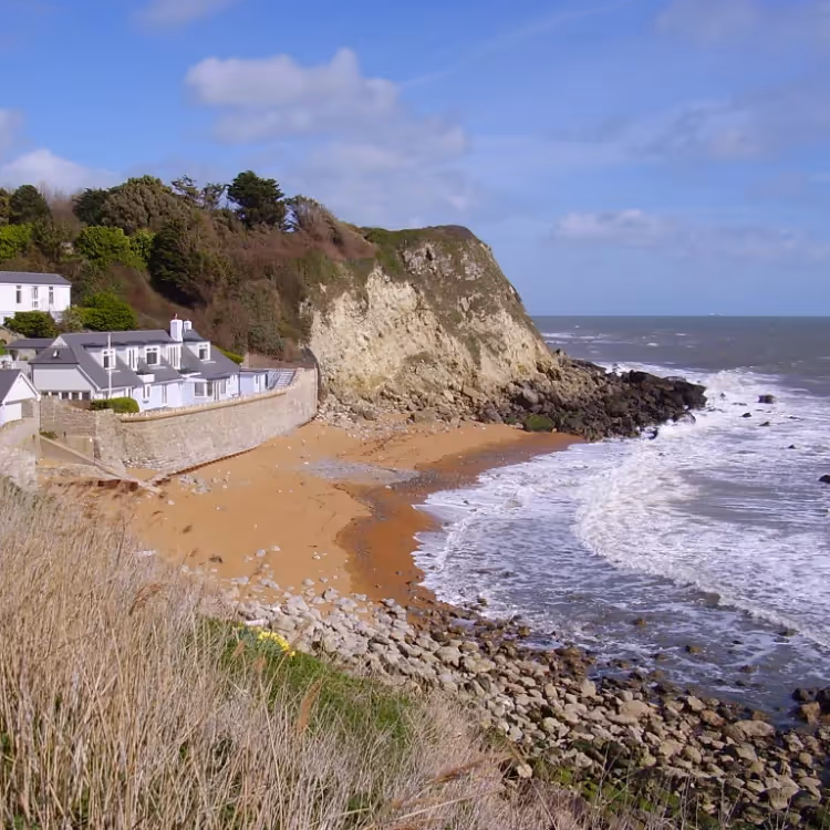 A house on the edge of a beach cove