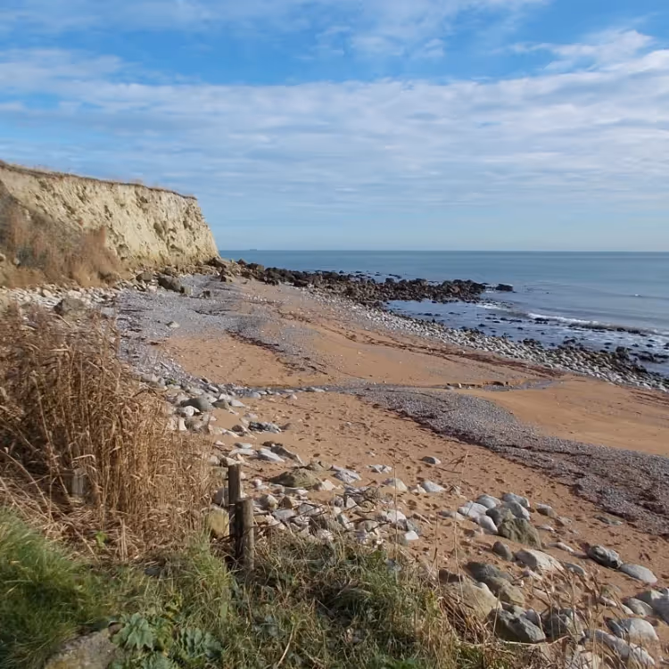 A secluded cove with a blue sky