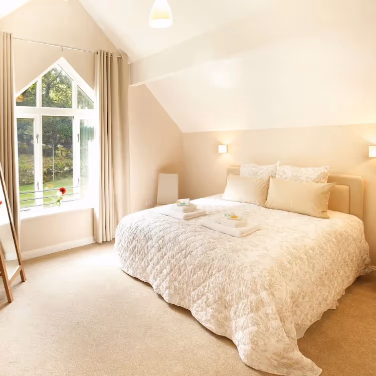 A light and airy bedroom with vaulted ceiling