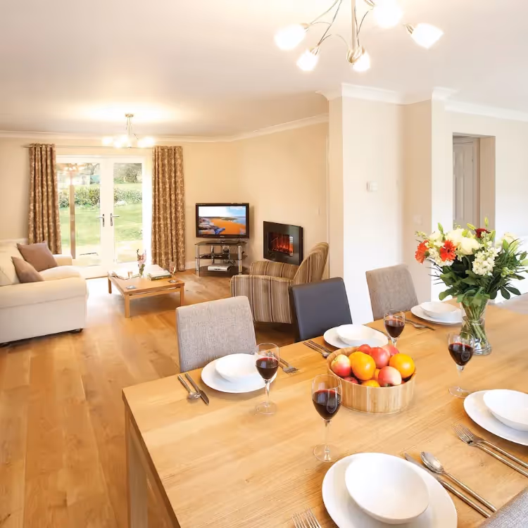 A modern dining room looking through to the living space beyond