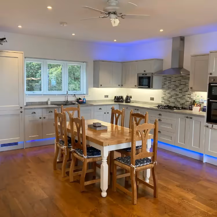 A modern kitchen with pine dining furniture