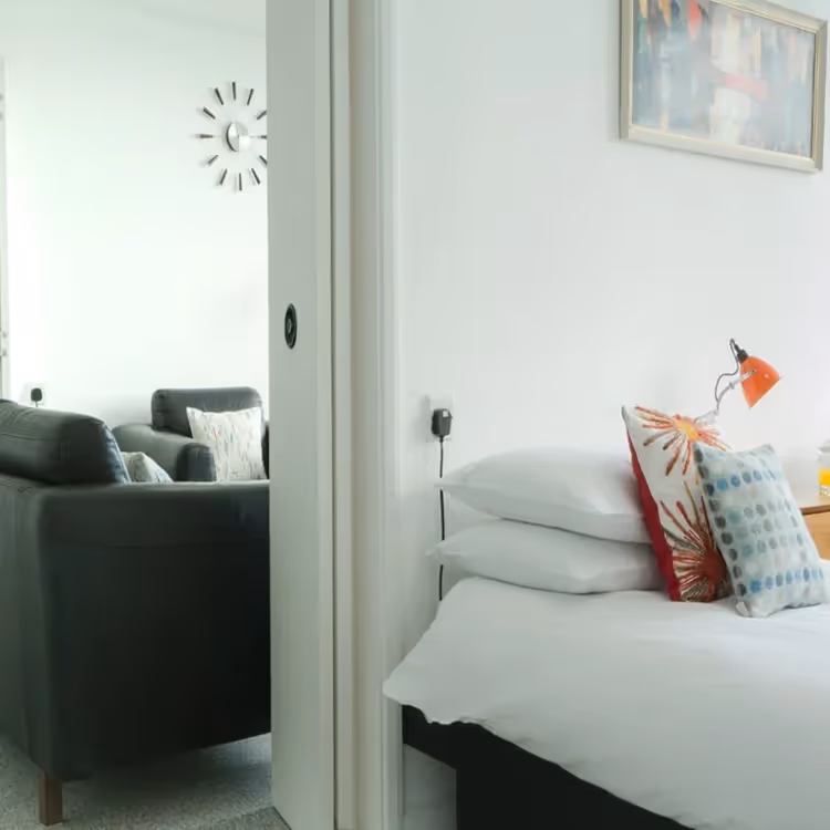A bedroom with connecting door to the living room