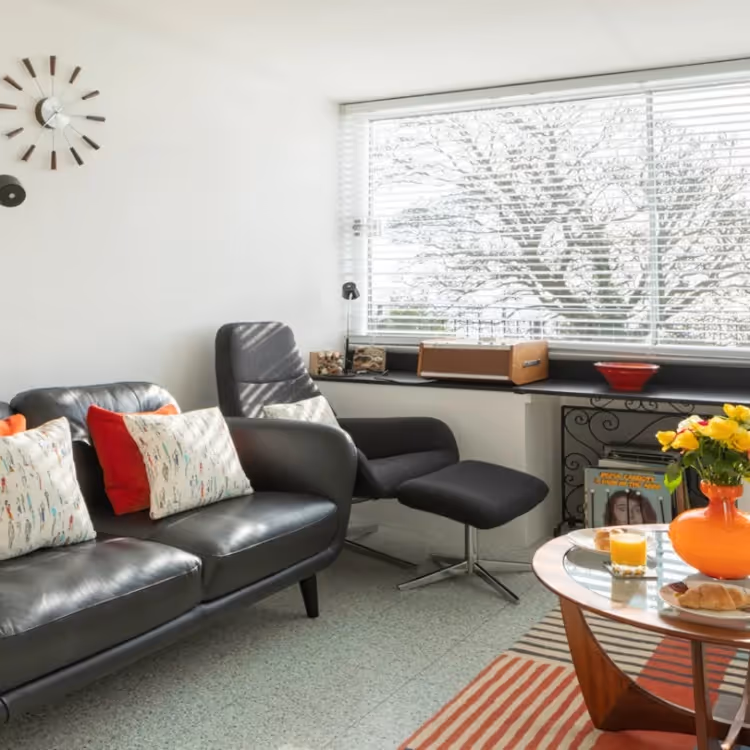 A snug with a leather sofa and a 1970s coffee table
