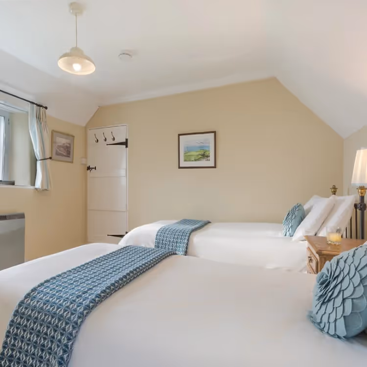 A cream and blue twin bedroom