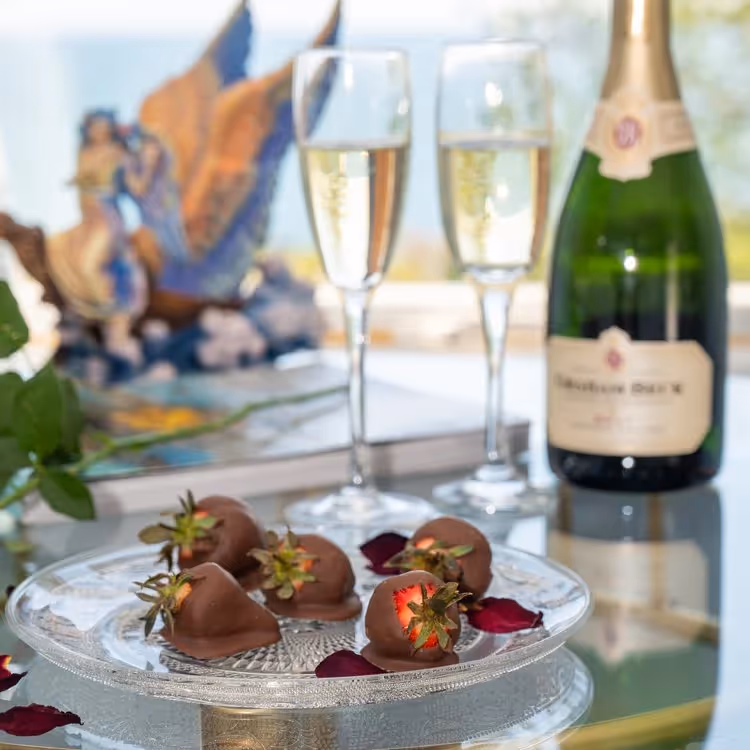 Champagne glasses and a plate of chocolate dipped strawberries