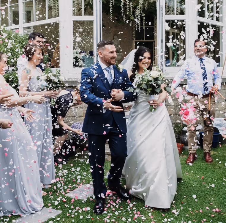 Confetti being thrown over the bride and groom