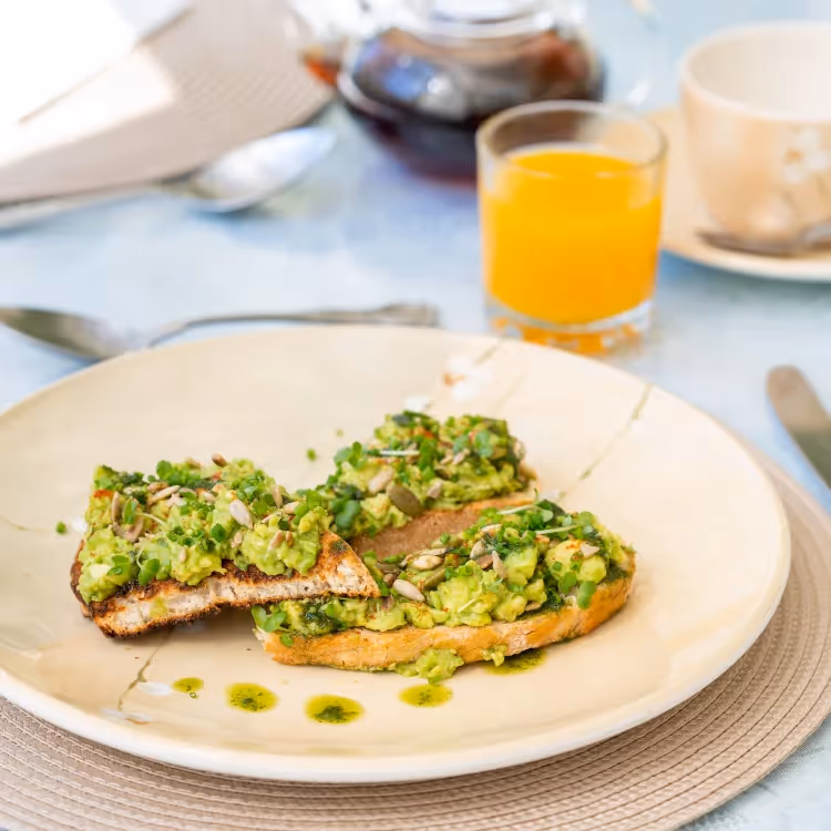 Avocado on toast with a glass of orange juice
